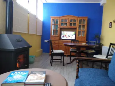 a living room with a fireplace and a tv at LA NURSERY DE MAS GUILLO in San Quintín de Mediona