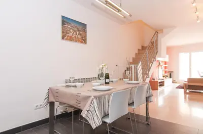 a dining room with a table and some chairs at Private terrace at Sagrada Familia in Barcelona