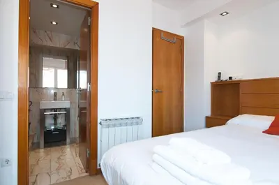 a bedroom with a bed with towels on it at Private terrace at Sagrada Familia in Barcelona