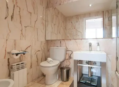 a bathroom with a toilet and a sink at Private terrace at Sagrada Familia in Barcelona