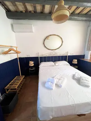 a bedroom with a bed with two towels on it at Masia St Salvador 1582 in Cubelles