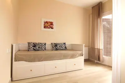 a bedroom with a bed with two pillows on it at Rubí: Luminoso apartamento a 1 minuto de la playa in Sitges