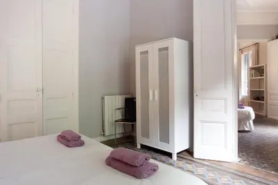 a bedroom with two purple towels on a bed at Modernist Apartment Barcelona in Barcelona