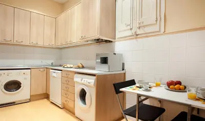 a kitchen with a washing machine and a dishwasher at Modernist Apartment Barcelona in Barcelona