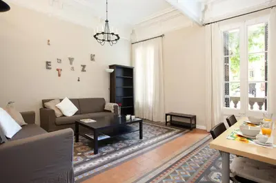 a living room with a couch and a table at Modernist Apartment Barcelona in Barcelona