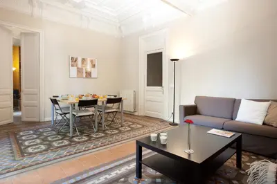 a living room with a couch and a table at Modernist Apartment Barcelona in Barcelona