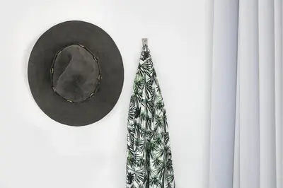 a hat and a tie hanging on a wall at Sant Jordi Hostels Rock Palace in Barcelona