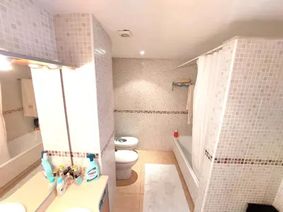a small bathroom with a toilet and a sink at BRAVAHOLIDAYS-201-Pineda in Pineda de Mar
