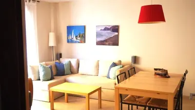 a living room with a couch and a table at BRAVAHOLIDAYS-201-Pineda in Pineda de Mar