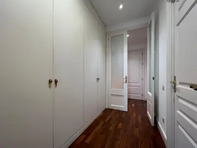 an empty hallway with white walls and wood floors at Stay Unique Apartments Bruc in Barcelona