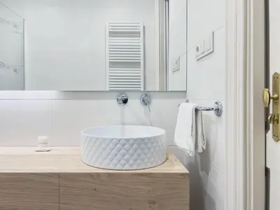 a white bathroom with a sink and a mirror at Stay Unique Apartments Bruc in Barcelona