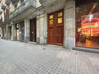an empty street with a building with wooden doors at Stay Unique Apartments Bruc in Barcelona