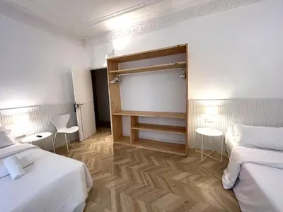 a hotel room with two beds and two tables at The MO GOTIC in Barcelona
