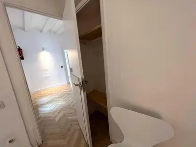 a hallway with a white door and a white chair at The MO GOTIC in Barcelona