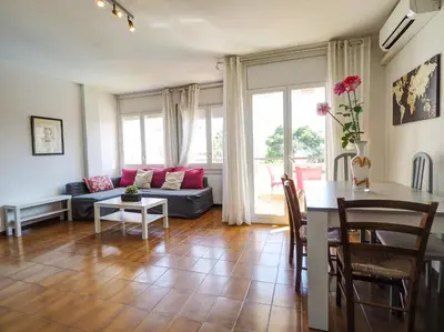 a living room with a couch and a table at Clarimar Sky Blue by Hello Homes Sitges in Sitges