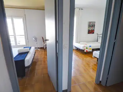 a room with a bedroom with a bed and a living room at Clarimar Sky Blue by Hello Homes Sitges in Sitges