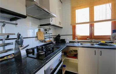 a kitchen with a stove and a sink at Nice Home In Sant Cebria De Vallalt in Sant Cebrià de Vallalta