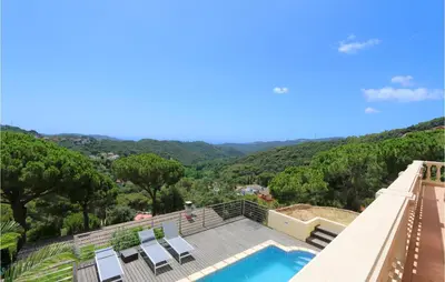 a villa with a pool and a view of the mountains at Nice Home In Sant Cebria De Vallalt in Sant Cebrià de Vallalta