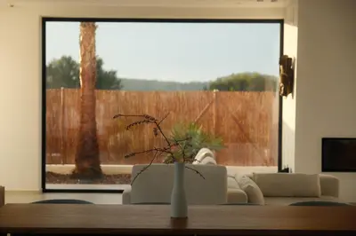 a living room with a couch and a table with a window at Contemporary villa near Sitges Hills in Avinyonet
