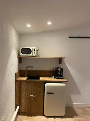 a small kitchen with a sink and a microwave at La Mer Hotel in Cabrera de Mar