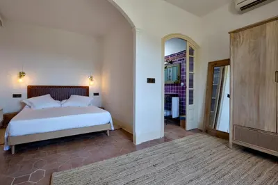a bedroom with a white bed and a mirror at La Mer Hotel in Cabrera de Mar
