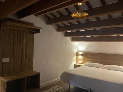 a bedroom with a bed and a wooden ceiling at La Mer Hotel in Cabrera de Mar