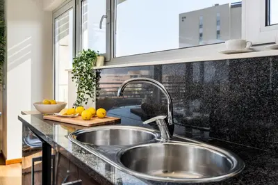a kitchen counter with a sink and a window at Lodging Apartments Forum Llull in Sant Adria de Besos
