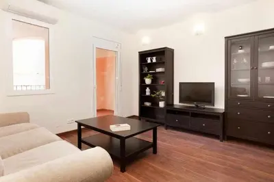 a living room with a couch and a coffee table at Apart céntrico con terraza en Gracia in Barcelona