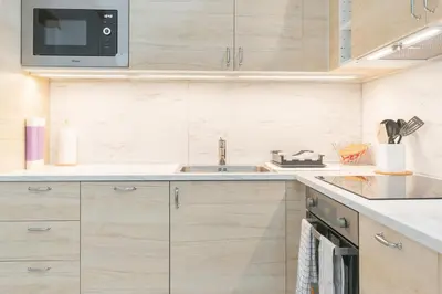 a kitchen with a sink and a microwave at NICE CITY CENTER APARTMENT in Vilanova i la Geltrú