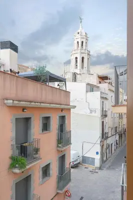 a view of a city with a church in the background at NICE CITY CENTER APARTMENT in Vilanova i la Geltrú