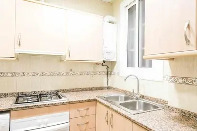 a kitchen with white cabinets and a sink at Port VIII Apart céntrico en Paralelo cerca Rambla in Barcelona
