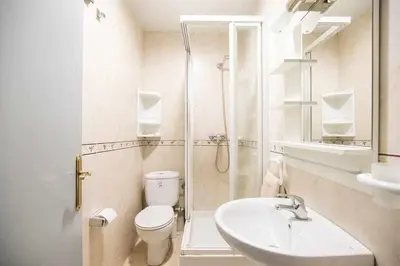 a bathroom with a toilet and a shower and a sink at Port VIII Apart céntrico en Paralelo cerca Rambla in Barcelona