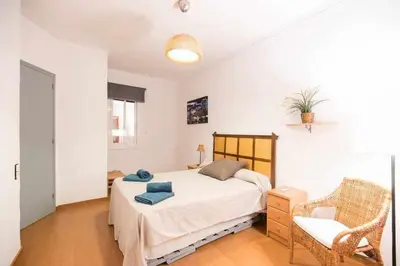 a bedroom with a bed and a chair in it at Port VIII Apart céntrico en Paralelo cerca Rambla in Barcelona