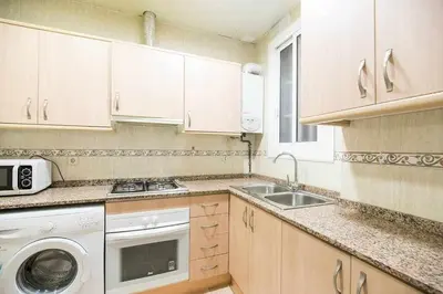 a kitchen with a sink and a washing machine at Port VIII Apart céntrico en Paralelo cerca Rambla in Barcelona