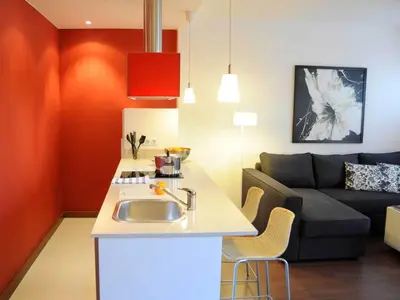 a kitchen and living room with a sink and a couch at Your Home in Barcelona Apartments in Barcelona