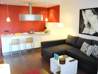 a living room with a couch and a kitchen at Your Home in Barcelona Apartments in Barcelona