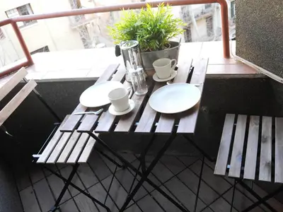 a table on a balcony with two mugs and cups at Your Home in Barcelona Apartments in Barcelona