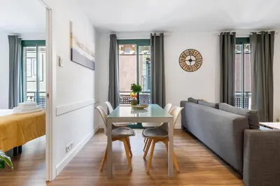 a living room with a table and a couch at Lodging Apartments Liceu G2 in Barcelona