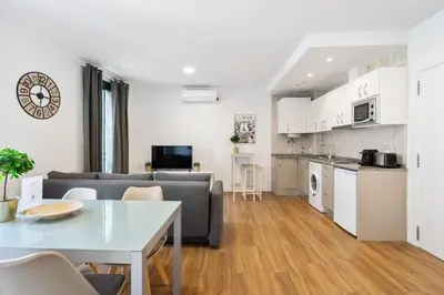 a living room with a couch and a table at Lodging Apartments Liceu G2 in Barcelona