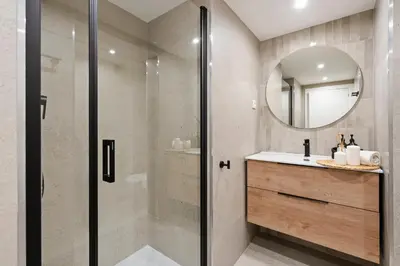 a bathroom with a shower and a sink and a mirror at Lodging Apartments Liceu 11 in Barcelona