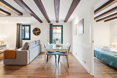 a living room with a table and a couch at Lodging Apartments Liceu 11 in Barcelona