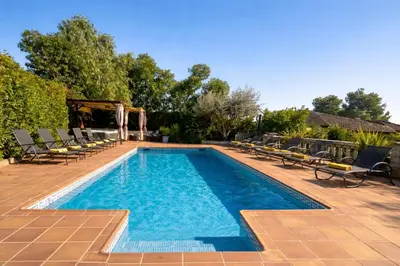 a swimming pool with chaise lounge chairs at Villa Sitges Ilusión 15 minutes by car from Sitges Sleeps 16 people XXL swimming pool in Olivella