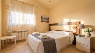 a bedroom with a large bed and a window at Villa Sitges Ilusión 15 minutes by car from Sitges Sleeps 16 people XXL swimming pool in Olivella