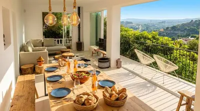 a living room with two tables and a couch at Villa Sitges Colonial. Impressive views of the sea. High design. Renovated. in Sitges