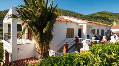 a table with plates and glasses on it next to a swimming pool at Villa Sitges Colonial. Impressive views of the sea. High design. Renovated. in Sitges