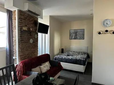 a living room with a bed and a couch at Nice apartment close to park Guell1 in Barcelona