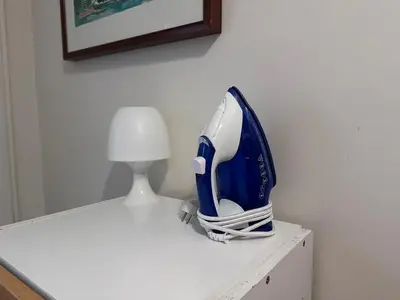 a blue and white iron sitting on top of a table at COMFORTABLE APARTMENT CLOSE TO BUNKERS DEL CARMEL! in Barcelona