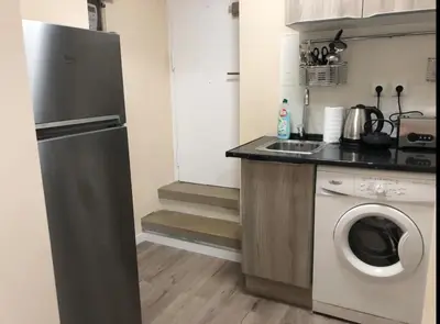 a kitchen with a washing machine and a sink at COMFORTABLE APARTMENT CLOSE TO BUNKERS DEL CARMEL! in Barcelona