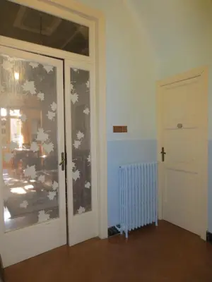 an empty room with a door and a window at 1900 B&B Terrassa in Terrassa