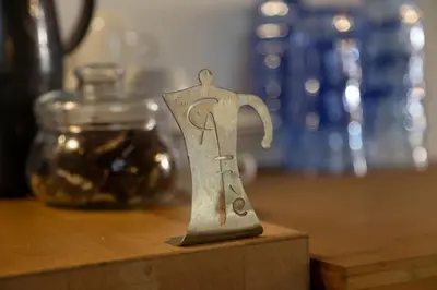 a small metal figurine sitting on top of a table at 1900 B&B Terrassa in Terrassa